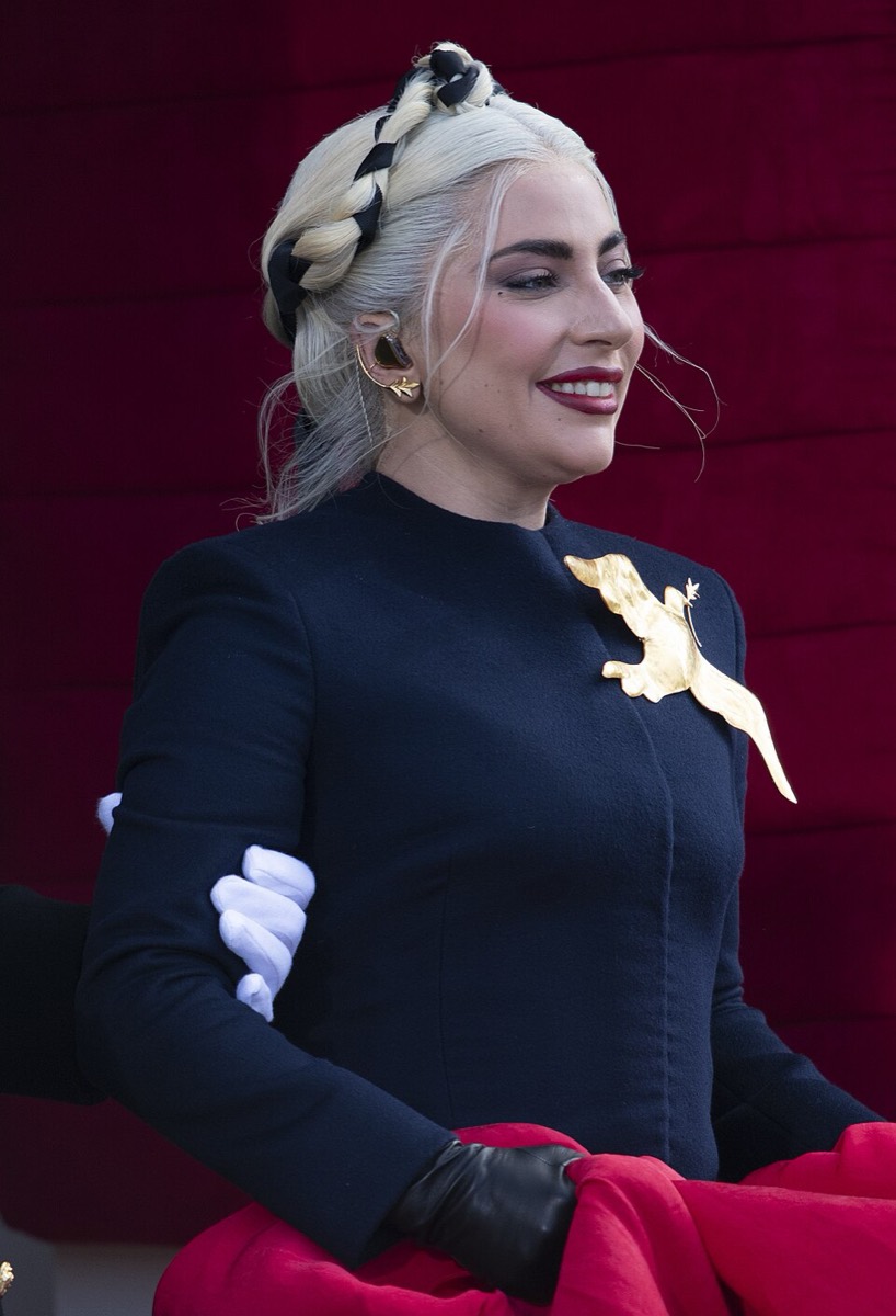 Lady Gaga: Navy jacket, dove brooch and red skirt