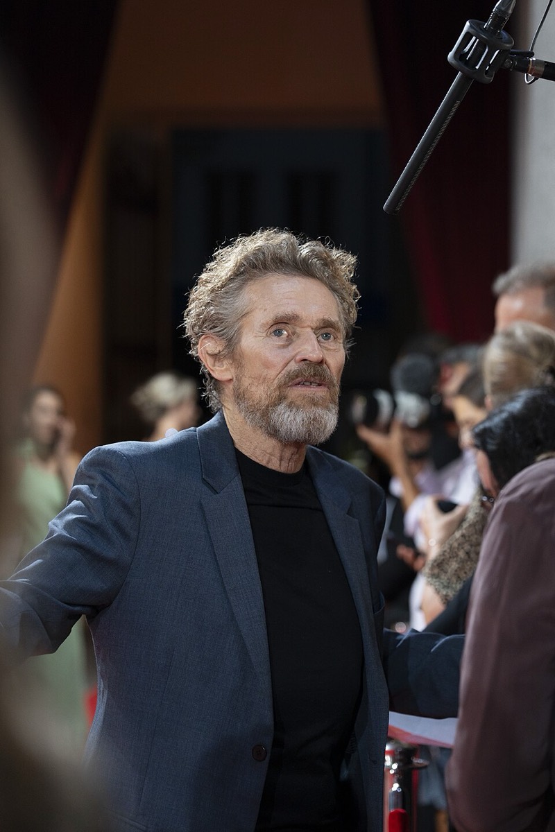 Willem Dafoe: Navy jacket and black knit